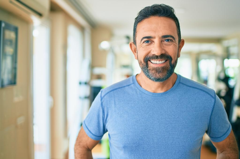 Prompt: A middle-aged man smiling, looking energetic and confident, maybe exercising or spending quality time with his partner, realistic style.